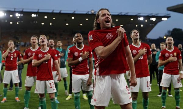 Hungary's striker Adam Szalai (C) leads the celebrations as Hungary's players celebrate in front of their supporters after the UEFA Nations League, league A group 3 football match between England and Hungary at Molineux Stadium in Wolverhampton, central England on June 14, 2022. Hungary won the game 4-0. PHOTO | AFP