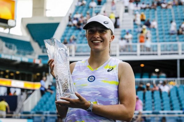 Iga Swiatek of Poland holds a trophy as she wins against Naomi Osaka of Japan in the finals of the women's singles at the Miami Open at the Hard Rock Stadium on April 02, 2022 in Miami Gardens, Florida. PHOTO | AFP