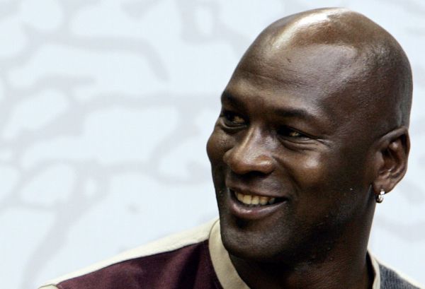 In this file photo taken former NBA Chicago Bulls basketball player Michael Jordan speaks to young basketball players as he is in Milan to promote a clothing line, October 24, 2006. NBA legend Michael Jordan decried "ingrained racism" in the United States as the sports world's reaction to the death of unarmed black man George Floyd leapt leagues and continents. "I am deeply saddened, truly pained and plain angry," Jordan said Sunday, as protests over Floyd's death on May 25 spawned violence and looting across the US. "I stand with those who are calling out the ingrained racism and violence toward people of color in our country. PHOTO | AFP
