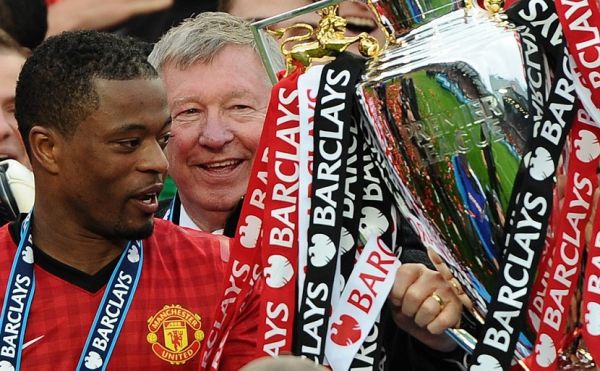 In this file photo taken on May 12, 2013 Manchester United's French defender Patrice Evra (L) and Manchester United manager Alex Ferguson (C) lift the Premier League trophy after the English Premier League football match between Manchester United and Swansea City at Old Trafford in Manchester. French former international Patrice Evra, 38, who played in Monaco, Manchester, Marseille, Juventus and West Ham, announced on July 29, 2019 his "carrier as a player is officially over" in the Italian Sport newspaper "Gazzetta dello Sport." PHOTO | AFP
