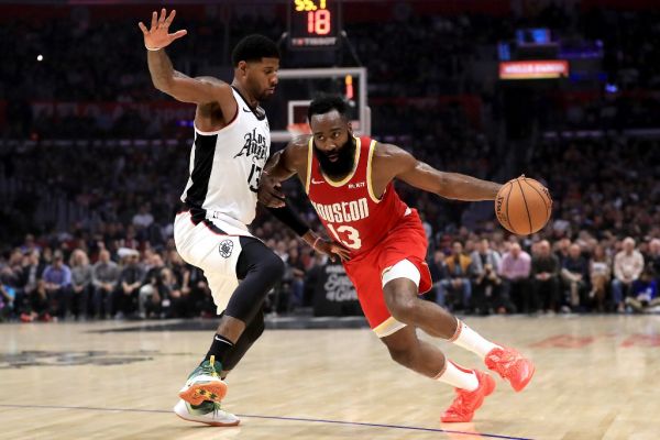 In this file photo taken on November 22, 2019 James Harden #13 of the Houston Rockets dribbles past Paul George #13 of the Los Angeles Clippers during the first half of a game at Staples Center in Los Angeles, California. James Harden tied Michael Jordan for the third most 60-point performances in NBA history on November 30, 2019 as the Houston Rockets blasted the last-place Atlanta Hawks 158-111.PHOTO | AFP