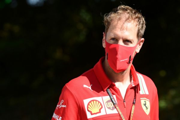 In this file photo taken on September 03, 2020 Ferrari's German driver Sebastian Vettel wears a protective face mask as he visits the track with team members at the Autodromo Nazionale circuit in Monza ahead of the Italian Formula One Grand Prix. Sebastian Vettel has signed for the renamed Aston Martin team for the 2021 season "and beyond", the ambitious British Formula One outfit announced on September 10, 2020. The 33-year-old German won four consecutive titles from 2010 to 2013 with Red Bull before joining Ferrari, but the Italian team has not renewed his contract. PHOTO | AFP