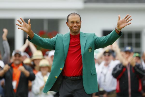 In this file photo Tiger Woods of the United States smiles after being awarded the Green Jacket during the Green Jacket Ceremony after winning the Masters at Augusta National Golf Club on April 14, 2019 in Augusta, Georgia. Reigning Masters champion Tiger Woods had a relaxed dinner with loved ones on April 7, 2020 instead of the Masters Champions Dinner he was once scheduled to host Tuesday at Augusta National. The Masters has been postponed to November by the coronavirus pandemic, with Woods, a 15-time major winner and five-time Masters champion, among those staying home to try and slow the spread of the deadly virus. PHOTO | AFP