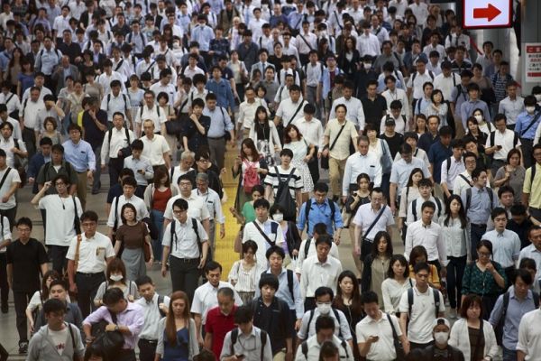 In this picture taken on July 18, 2019 people commute during a morning rush hour at Shinagawa station in Tokyo. Japan's workers spend more hours at the office than employees in almost any other country. But to avoid traffic chaos at next year's Olympics, authorities have a message: stay home. Hundreds of thousands of people are expected to attend Olympic and Paralympic events in Tokyo during the 2020 Games, putting additional strain on the city's already notoriously crowded commuter routes. PHOTO | AFP