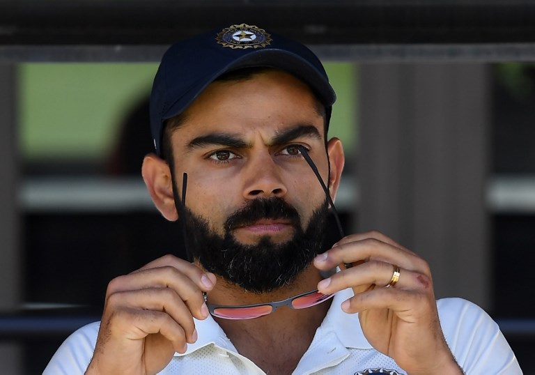 India's captain Virat Kohli (C) sits on the players bench at the end of second Test cricket match between Australia and India in Perth on December 18, 2018. PHOTO/AFP