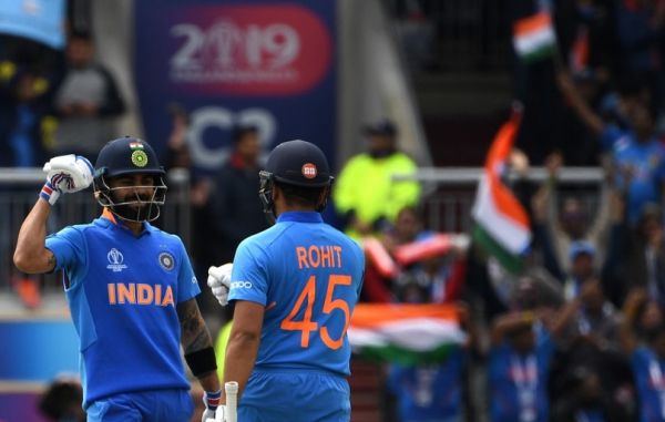 India's captain Virat Kohli (L) celebrates with teammate Rohit Sharma after the innings passed 150 during the 2019 Cricket World Cup group stage match between India and Pakistan at Old Trafford in Manchester, northwest England, on June 16, 2019. PHOTO | AFP