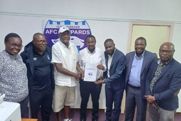 Ingwe a 60 committee chairman Elder Vincent Shimoli handing over the Ingwe @60 report to the club's National committee.PHOTO/AFC Leopards Media.