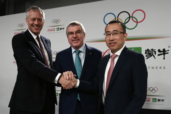 International Olympic Committee (IOC) president Thomas Bach (C) shakes hands with Coca-Cola President and CEO James Quincey (L) and China Mengniu Dairy CEO and Executive Director Jeffrey Minfang as they pose for photos during a press conference as part of the 134th Session of the International Olympic Committee (IOC) at the SwissTech Convention Centre in Lausanne, on June 24, 2019. PHOTO | AFP