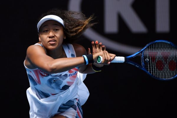 Japan's Naomi Osaka hits a return against China's Zheng Saisai during their women's singles match on day three of the Australian Open tennis tournament in Melbourne on January 22, 2020. PHOTO | AFP