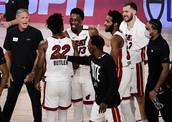 Jimmy Butler #22 of the Miami Heat and Bam Adebayo #13 of the Miami Heat react after their win over Boston Celtics during overtime in Game One of the Eastern Conference Finals during the 2020 NBA Playoffs at The Field House at the ESPN Wide World Of Sports Complex on September 15, 2020 in Lake Buena Vista, Florida. PHOTO | AFP