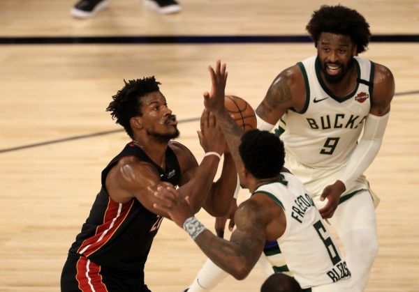 Jimmy Butler #22 of the Miami Heat drives to the basket against Eric Bledsoe #6 of the Milwaukee Bucks and Wesley Matthews #9 of the Milwaukee Bucks during the second quarter in Game Five of the Eastern Conference Second Round during the 2020 NBA Playoffs at The Field House at the ESPN Wide World Of Sports Complex on September 08, 2020 in Lake Buena Vista, Florida. PHOTO | AFP