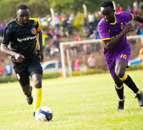 John Kiplagat of Murang'a Seal (left) carries the ball past Wazito's Elli Asieche during the second leg of their FKF Kenya Premier League promotion/relegation playoff at St. Sebastian Park in Murang'a on Sunday, August 7, 2021. PHOTO | Mike Odinga | SPN