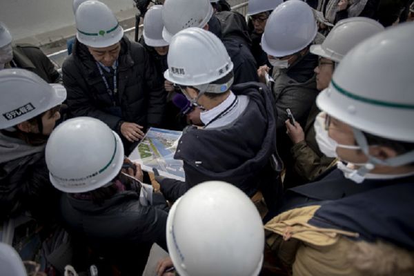 Journalists receive a briefing during a media tour to construction sites of the Sea Forest Waterway for canoe sprint and rowing event venue at the Tokyo 2020 Olympics Tuesday, Feb. 12, 2019, in Tokyo. PHOTO/ GETTY IMAGES