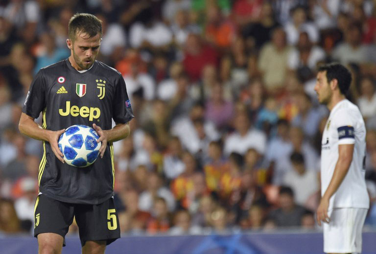 Juventus' Bosnian defender Miralem Pjanic grabs the ball during the UEFA Champions League group H football match between Valencia CF and Juventus FC at the Mestalla stadium in Valencia on September 19, 2018. PHOTO/AFP