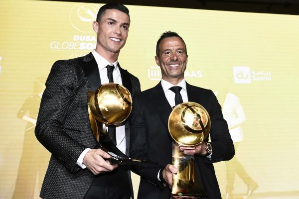 Juventus' Portuguese forward Cristiano Ronaldo (L), holding his "Best Player of the Year 2018 Award" and Portuguese football agent Jorge Mendes, holding his "Best Agent of the Year 2018 Award" pose during the 10th edition of the Dubai Globe Soccer Awards on January 3, 2019 in Dubai. PHOTO | AFP