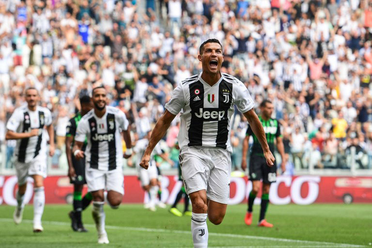 Juventus' Portuguese forward Cristiano Ronaldo (R) celebrates after scoring his first goal since he joined Juventus, during the Italian Serie A football match Juventus vs Sassuolo on September 16, 2018 at the Juventus stadium in Turin. PHOTO/AFP