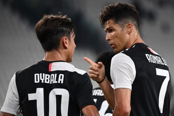 Juventus' Portuguese forward Cristiano Ronaldo celebrates with Juventus' Argentine forward Paulo Dybala (L) after scoring a penalty during the Italian Serie A football match Juventus Turin vs Atalanta Bergamo played behind closed doors on July 11, 2020 at the Juventus stadium in Turin, as the country eases its lockdown aimed at curbing the spread of the COVID-19 infection, caused by the novel coronavirus. PHOTO | AFP