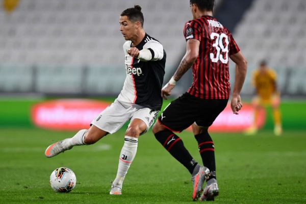 Juventus' Portuguese forward Cristiano Ronaldo challenges AC Milan's Brazilian midfielder Lucas Paqueta during the Italian Cup (Coppa Italia) semi-final second leg football match Juventus vs AC Milan on June 12, 2020 at the Allianz stadium in Turin, the first to be played in Italy since March 9 and the lockdown aimed at curbing the spread of the COVID-19 infection, caused by the novel coronavirus. PHOTO | AFP