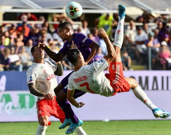 Juventus' Portuguese forward Cristiano Ronaldo performs an overhead kick despite Fiorentina's Brazilian defender Dalbert (Rear C) during the Italian Serie A football match Fiorentina vs Juventus on September 14, 2019 at the Artemio-Franchi stadium in Florence. PHOTO | AFP