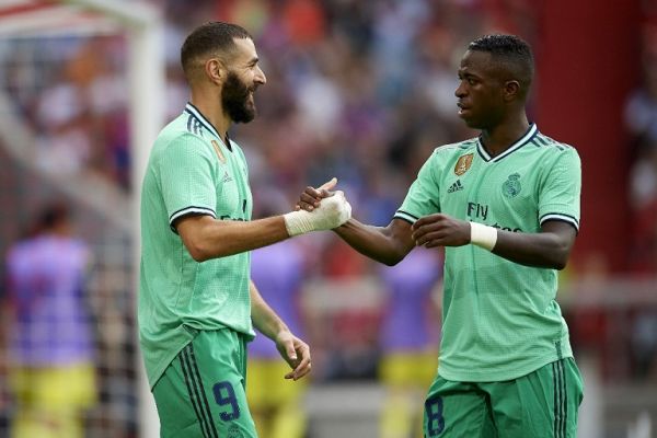 Karim Benzema of Real Madrid celebrates whit Vinicius Junior after scoring his sides third goal during the Audi cup 2019 3rd place match between Real Madrid and Fenerbahce at Allianz Arena on July 31, 2019 in Munich, Germany. PHOTO | AFP