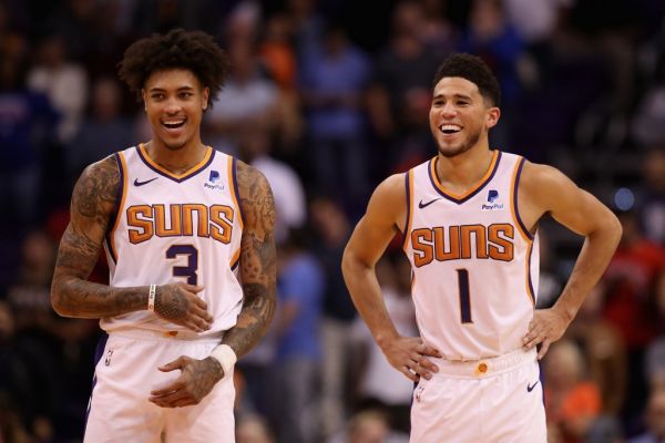 Kelly Oubre Jr. #3 and Devin Booker #1 of the Phoenix Suns react during the final moments of the second half of the NBA game against the Phoenix Suns at Talking Stick Resort Arena on November 04, 2019 in Phoenix, Arizona. The Suns defeated the 76ers 114-109. PHOTO | AFP