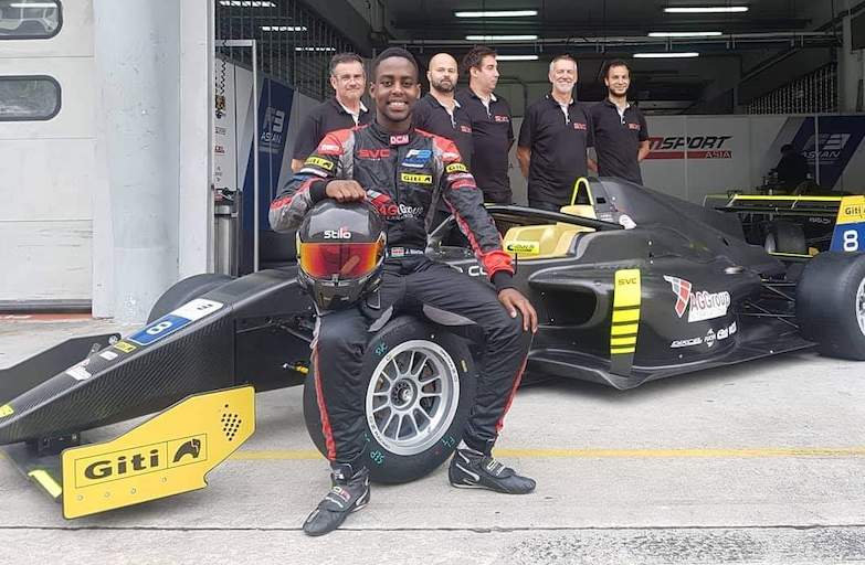 Kenya Formula 1 racing hopeful, Jeremy Wahome poses with his team in their Formula 3 paddock. PHOTO/Courtesy