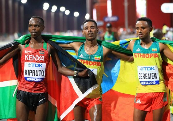 Kenya's Amos KIPRUTO, bronze, Ethiopia's Lelisa DESISA, gold, and Mosinet GEREMEW, bronze, pose for photo after the Marathon Men of IAAF WORLD ATHLETICS CHAMPIONSHIPS, DOHA 2019 in Doha, Qatar on October 6, 2019. PHOTO | AFP