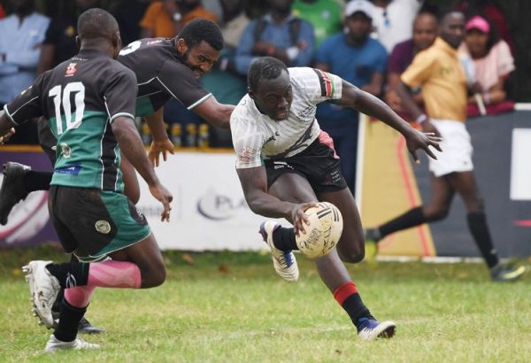 Kenya's Billy Odhiambo scores a try during the Africa Men's Sevens World Cup Qualifying Tournament match between Kenya and Zimbabwe at the Kayadondo Rugby Grounds in Kampala on April 23, 2022. PHOTO | AFP