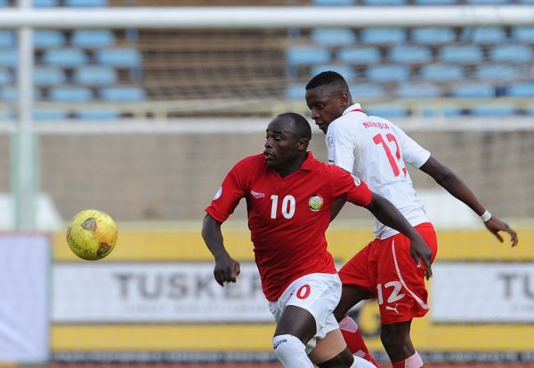 Kenya's Dennis Oliech (L) vies with Namibia's Katjiukua Chris during the World Cup 2014 qualifying football match Kenya vs Namibia, on September 8, 2013 in Nairobi. Kenya won 1 to 0. PHOTO | AFP