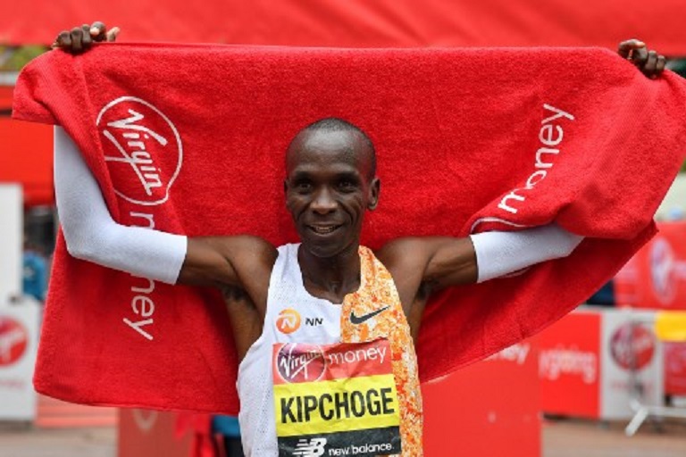 Kenya's Eliud Kipchoge poses for a photograph after winning the elite men's race of the 2019 London Marathon in central London on April 28, 2019. Kenya's Eliud Kipchoge won the men's London Marathon on Sunday in an unofficial time of 2 hours two minutes and 37 seconds -- the second fastest time for a marathon. PHOTO/AFP
