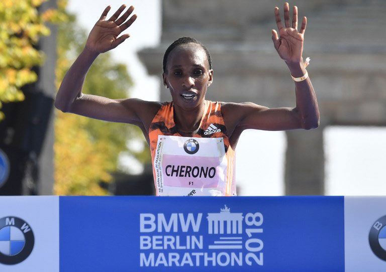 Kenya's Gladys Cherono celebrates cutting the tape to win the 2018 BMW Berlin Marathon on Sunday, September 16, 2018. PHOTO/AFP