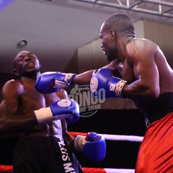 Kenya's Rayton Okwiri (right) lands a right hook on Ugandan John Serunjogi in a non-title bout in Dar es Salaam, Tanzania on Wednesday, October 13, 2021. PHOTO | Courtesy