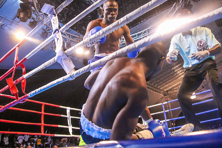 Kenya's Rayton Okwiri stands over the prone Ugandan opponent, Patrick Omoti after sending him to the canvas in the second round of their non-title fight at KICC on Saturday, September 8, 2018. PHOTO/SPN