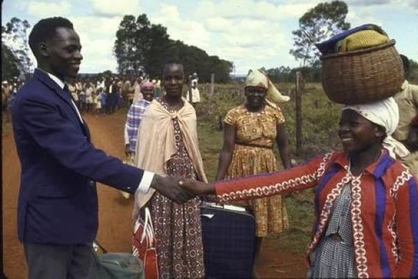 Kenyan Legend Amos Biwott(left) shaking hands with a woman after returning from an international assignment. PHOTO/Imago