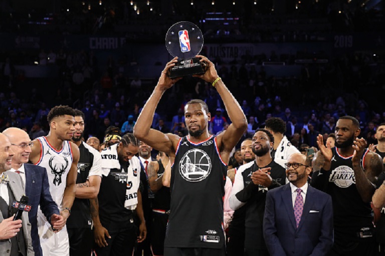Kevin Durant #35 of the Golden State Warriors and Team LeBron celebrates with the MVP trophy after their 178-164 win over Team Giannis during the NBA All-Star game as part of the 2019 NBA All-Star Weekend at Spectrum Center on February 17, 2019 in Charlotte, North Carolina. PHOTO/GettyImages