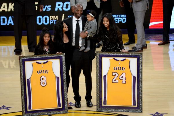 Kobe Bryant poses with his family at halftime after both his #8 and #24 Los Angeles Lakers jerseys are retired at Staples Center on December 18, 2017 in Los Angeles, California. PHOTO | AFP