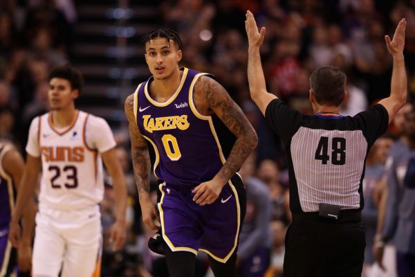 Kyle Kuzma #0 of the Los Angeles Lakers reacts after hitting a three point shot over Cameron Johnson #23 of the Phoenix Suns during the second half of the NBA game at Talking Stick Resort Arena on November 12, 2019 in Phoenix, Arizona. The Lakers defeated the Suns 123-115. PHOTO | AFP