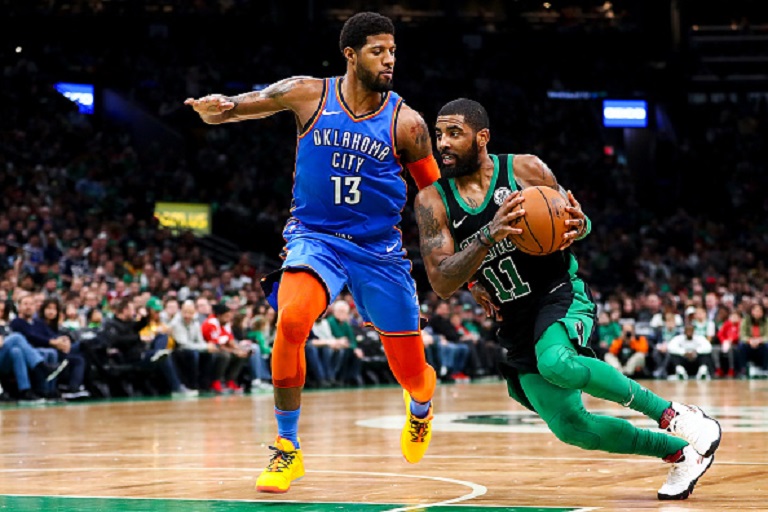 Kyrie Irving #11 of the Boston Celtics drives to the basket past Paul George #13 of the Oklahoma City Thunder during a game at TD Garden on February 3, 2019 in Boston, Massachusetts. PHOTO/GettyImages