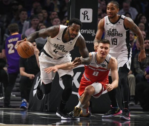 LA Clippers forward JaMychal Green (4) grabs a loose ball away from Sacramento Kings guard Bogdan Bogdanovic (8) during the fourth quarter at Staples Center. PHOTO | AFP