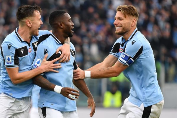 Lazio's Spanish defender Patric (L) and Lazio's Italian forward Ciro Immobile (R) congratulate Lazio's Angolan defender Bastos after he scored during the Italian Serie A football match Lazio Rome vs Sampdoria on January 18, 2020 at the Olympic stadium in Rome. PHOTO | AFP