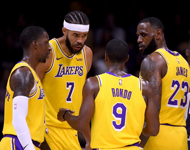 LeBron James #23, Rajon Rondo #9, JaVale McGee #7 and Kentavious Caldwell-Pope #1 of the Los Angeles Lakers talk after a stop in play during a preseason game against the Denver Nuggets at Valley View Casino Center on September 30, 2018 in San Diego, California. PHOTO/AFP