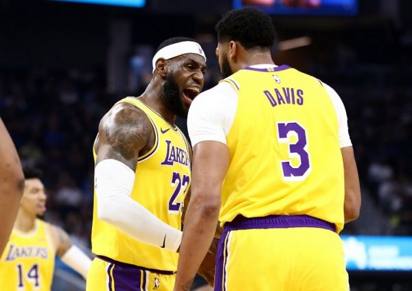 LeBron James #23 congratulates Anthony Davis #3 of the Los Angeles Lakers after he made a basket against the Golden State Warriors at Chase Center on October 05, 2019 in San Francisco, California. PHOTO | AFP