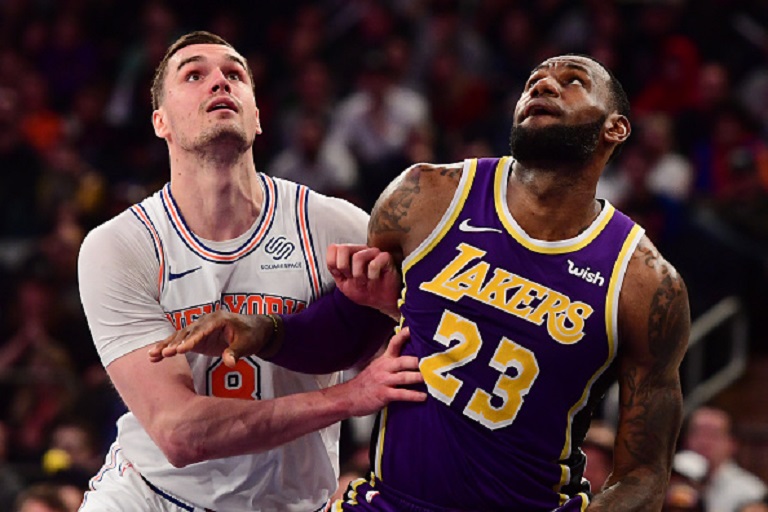 LeBron James #23 of the Los Angeles Lakers guards Mario Hezonja #8 of the New York Knicks during the second half of the game at Madison Square Garden on March 17, 2019 in New York City. PHOTO/GettyImages