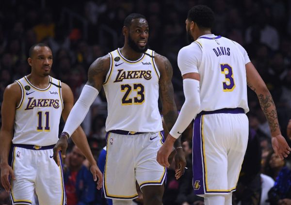 LeBron James #23 of the Los Angeles Lakers reacts between Avery Bradley #11 and Anthony Davis #3 during a 112-103 win over the LA Clippers at Staples Center on March 08, 2020 in Los Angeles, California. PHOTO | AFP