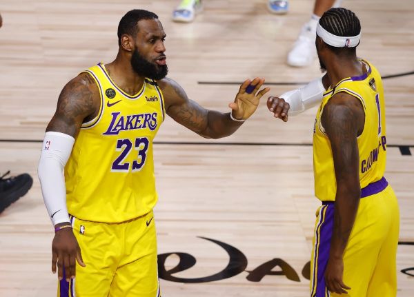 LeBron James #23 of the Los Angeles Lakers reacts with Kentavious Caldwell-Pope #1 of the Los Angeles Lakers after drawing a foul during the fourth quarter against the Miami Heat in Game Four of the 2020 NBA Finals at AdventHealth Arena at the ESPN Wide World Of Sports Complex on October 6, 2020 in Lake Buena Vista, Florida. PHOTO | AFP