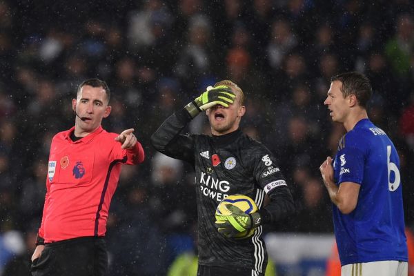 Leicester City's Danish goalkeeper Kasper Schmeichel (C) reacts to a decision of referee Christopher Kavanagh (L) as Leicester City's Northern Irish defender Jonny Evans (R) looks on during the English Premier League football match between Leicester City and Arsenal at King Power Stadium in Leicester, central England on November 9, 2019. PHOTO | AFP