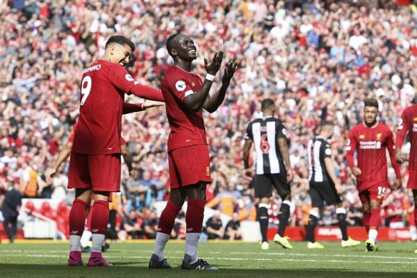 Liverpool forward Sadio Mane (10) celebrates his goal 2-1 with Liverpool forward Roberto Firmino (9) during the English championship Premier League football match between Liverpool and Newcastle United on September 14, 2019 at Anfield in Liverpool, England. PHOTO | AFP