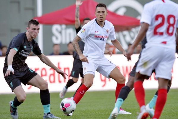 Liverpool's Andy Robertson (L) and Sevilla's Lucas Ariel Ocampos make a quick turn to follow the ball during a pre-season friendly match between Liverpool FC and Sevilla FC at Fenway Park in Boston on July 21, 2019. PHOTO | AFP