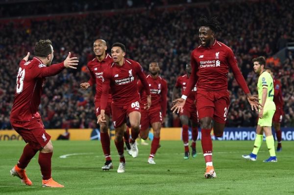 Liverpool's Belgian striker Divock Origi (R) celebrates after scoring their fourth goal during the UEFA Champions league semi-final second leg football match between Liverpool and Barcelona at Anfield in Liverpool, north west England on May 7, 2019. PHOTO/AFP