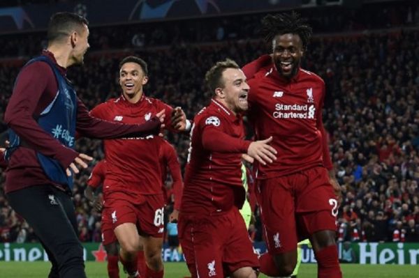 Liverpool's Belgium striker Divock Origi (R) celebrates wtih Liverpool's Swiss midfielder Xherdan Shaqiri after scoring their fourth goal during the UEFA Champions league semi-final second leg football match between Liverpool and Barcelona at Anfield in Liverpool, north west England on May 7, 2019. PHOTO/AFP